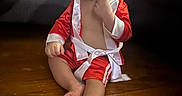 Mateo joined the competition — help win amazing prizes! baby, boxing_robe, child, couch, curious, cute, expression, finger_in_mouth, floor, home, indoors, living_room, person, red_clothing, sitting, toddler, toy, white_trim, wooden_floor, young_child