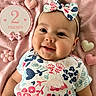 baby, infant, smile, face, headband, bow, floral_shirt, pink_blanket, heart_decoration, flower_decoration, milestone_sign, cute, adorable, child, portrait, happy, lying_down, two_months, celebration, soft_texture
