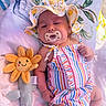 Sophia Green joined the competition — help win amazing prizes! baby, infant, pacifier, sun_hat, plush_toy, stuffed_animal, flower_toy, striped_clothing, colorful, blanket, resting, cute, outdoor, soft_toy, child, smiling_toy, summer, laying_down, playful, relaxed
