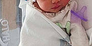 Ariya is registered to the contest to win money with this photo: baby, bed, blanket, child, cozy, cute, head_wrap, healthcare, hospital, indoors, infant, newborn, pacifier, peaceful, person, rest, sleeping, soft, swaddled, wrapped