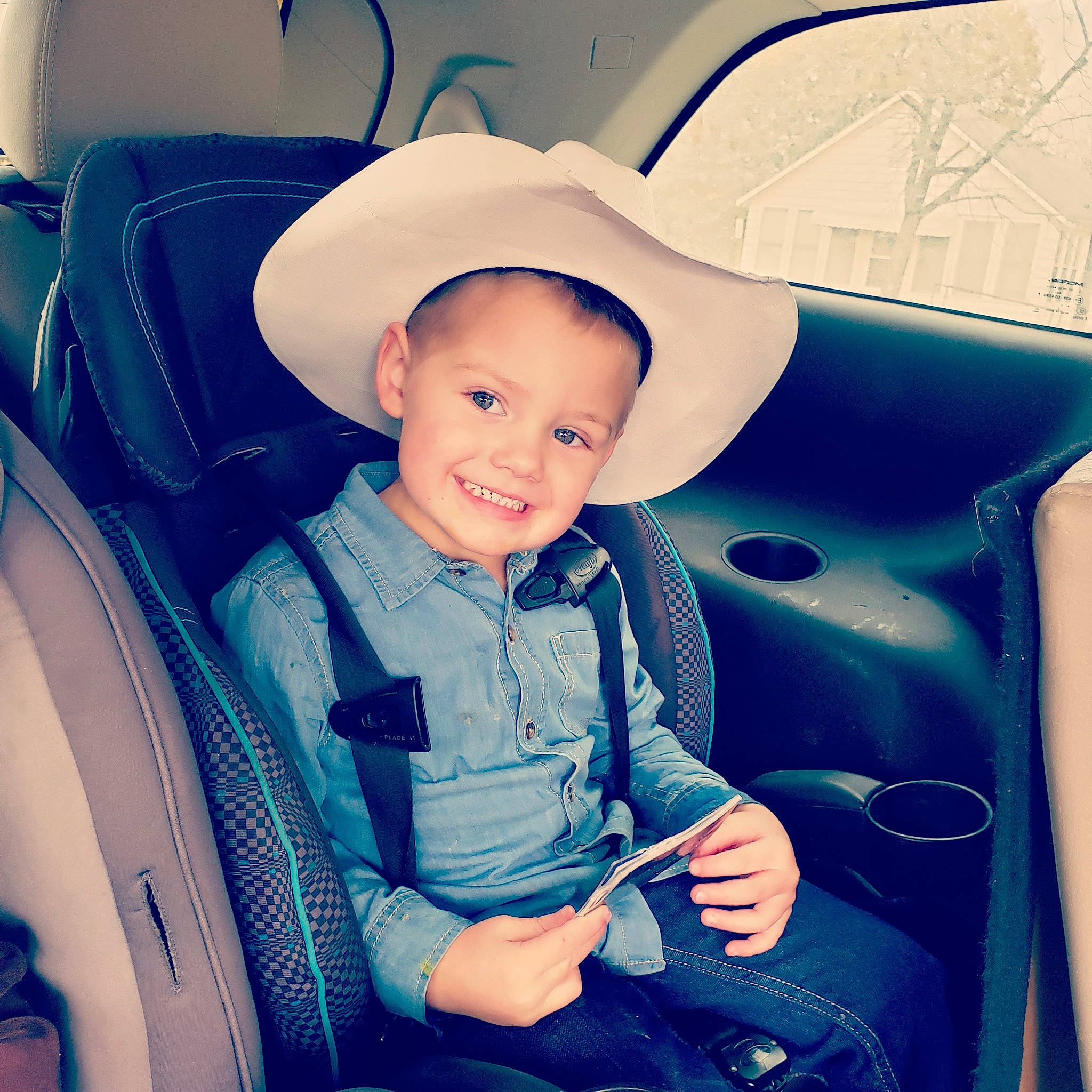 Hurley is registered to the contest to win money with this photo: auto_part, baby, baby_in_car_seat, blue, car, car_seat, car_seat_cover, child, cool, family_car, fun, joy, person, product, sitting, skin, smile, toddler, vacation, vehicle