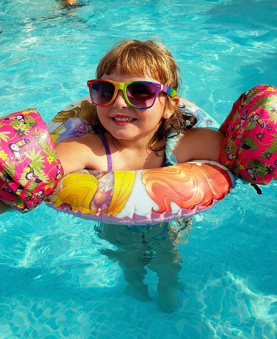 Peyton joined the competition — help win amazing prizes! baby_float, child, cool, eyewear, fun, games, glasses, joy, leisure, person, personal_protective_equipment, product, recreation, smile, summer, sunglasses, swimming, swimming_pool, swimwear, toddler