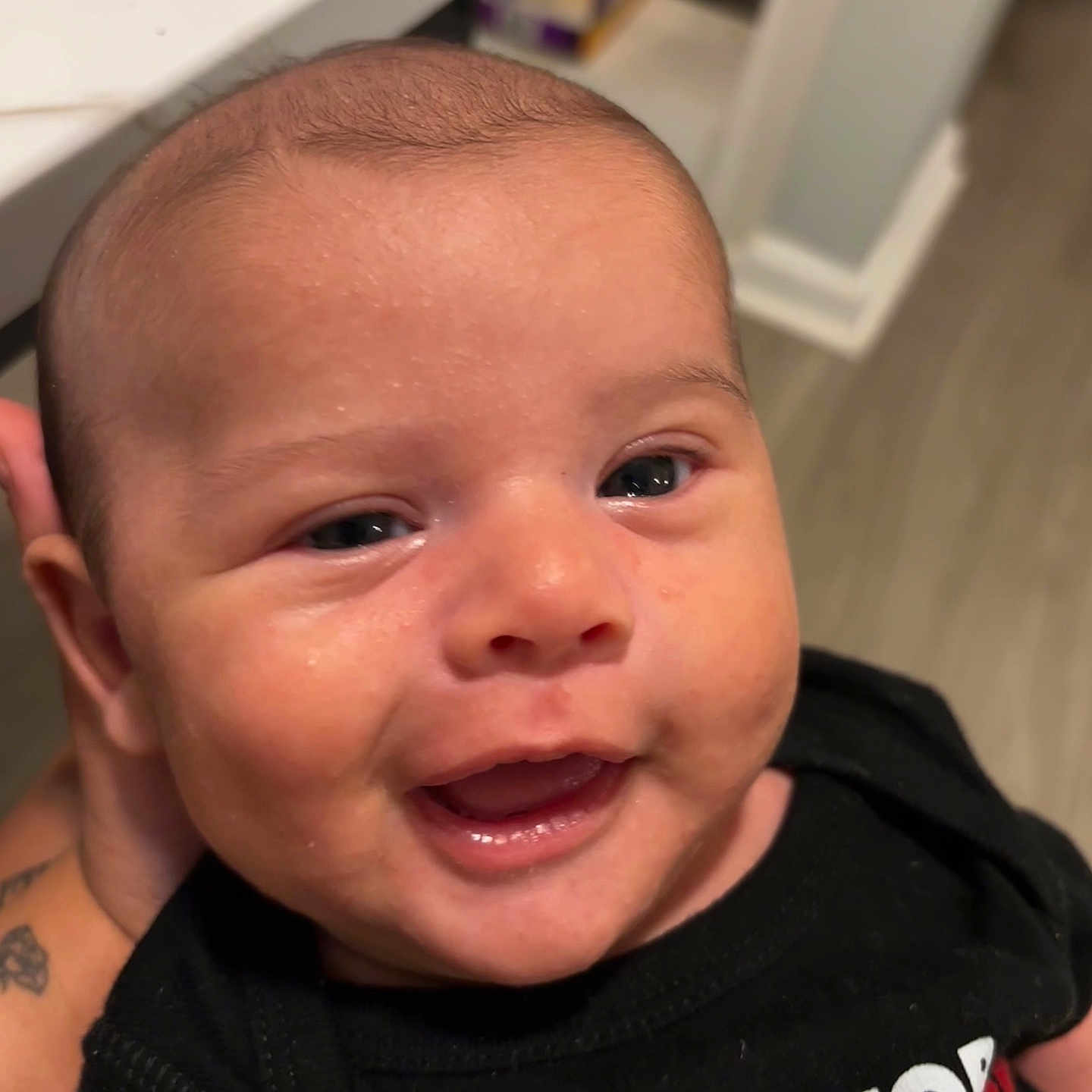 Carter is registered to the contest to win money with this photo: baby, babylaughing, bodypart, clothing, face, happy, head, laughing, mouth, newborn, person, photography, portrait, skin, smile, t_shirt, tattoo, teeth