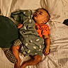 baby, sleeping, blanket, bed, pillow, clothing, footwear, socks, infant, peaceful, indoors, cozy, rest, person, portrait, soft, comfort, cute, child, lying_down