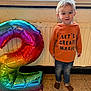 Athanael a rejoint le concours — aidez-le/la à gagner de superbes lots ! toddler, child, balloon, number_two, rainbow, indoor, hoodie, jeans, socks, smiling, floor, window, radiator, celebration, birthday, standing, casual_clothing, happy, person, cute
