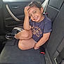 backseat, car_interior, casual_clothing, child, cute, daylight, girl, hair_braids, happy, indoors, person, playful, portrait, seat, seatbelt, shoe, sitting, smiling, window, young