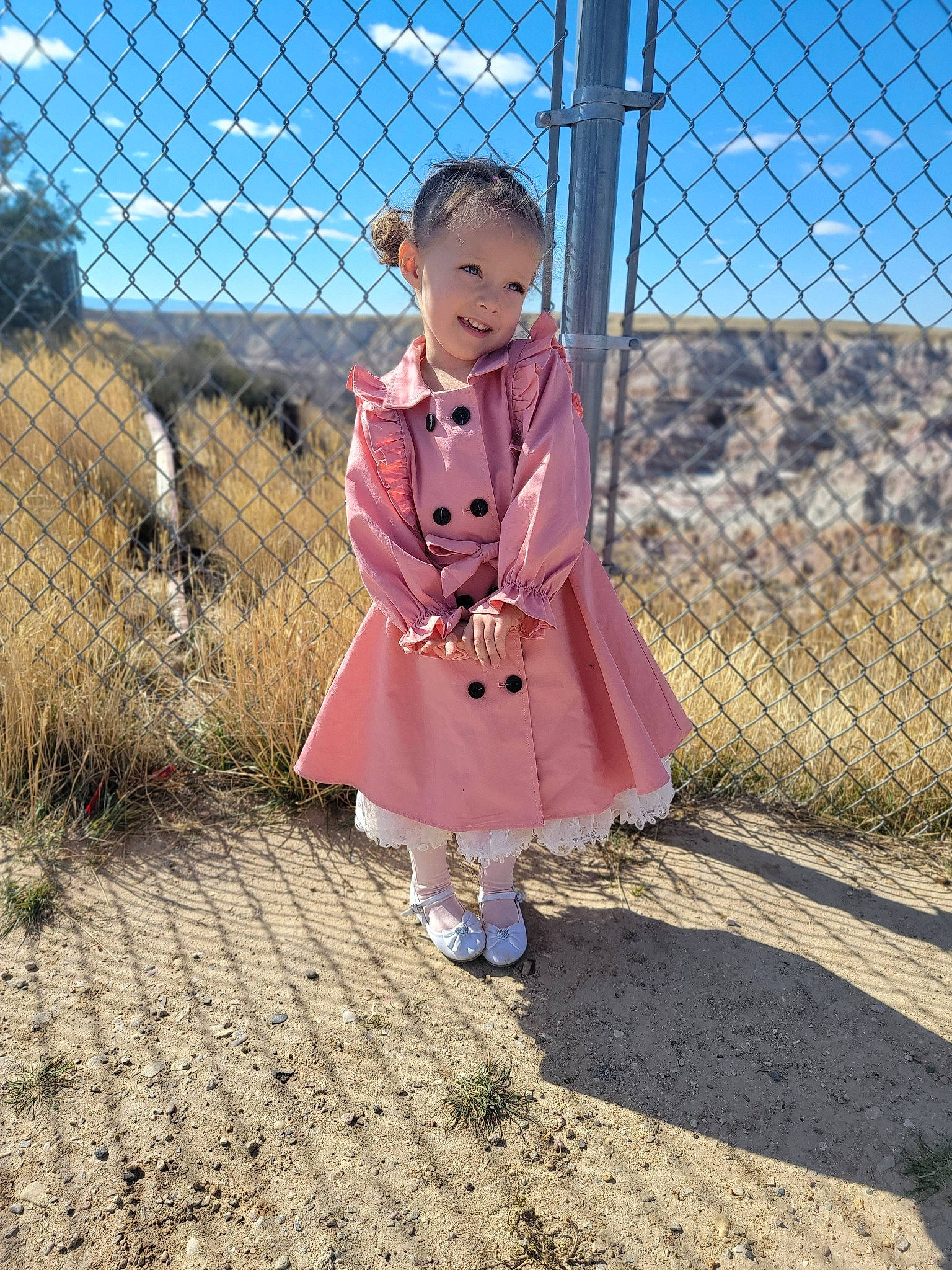 Maliyah is registered to the contest to win money with this photo: baby_toddler_clothing, chain_link_fencing, child, dress, electric_blue, fence, grass, hat, home_fencing, joy, landscape, magenta, mesh, metal, pattern, person, plant, sky, sleeve, smile