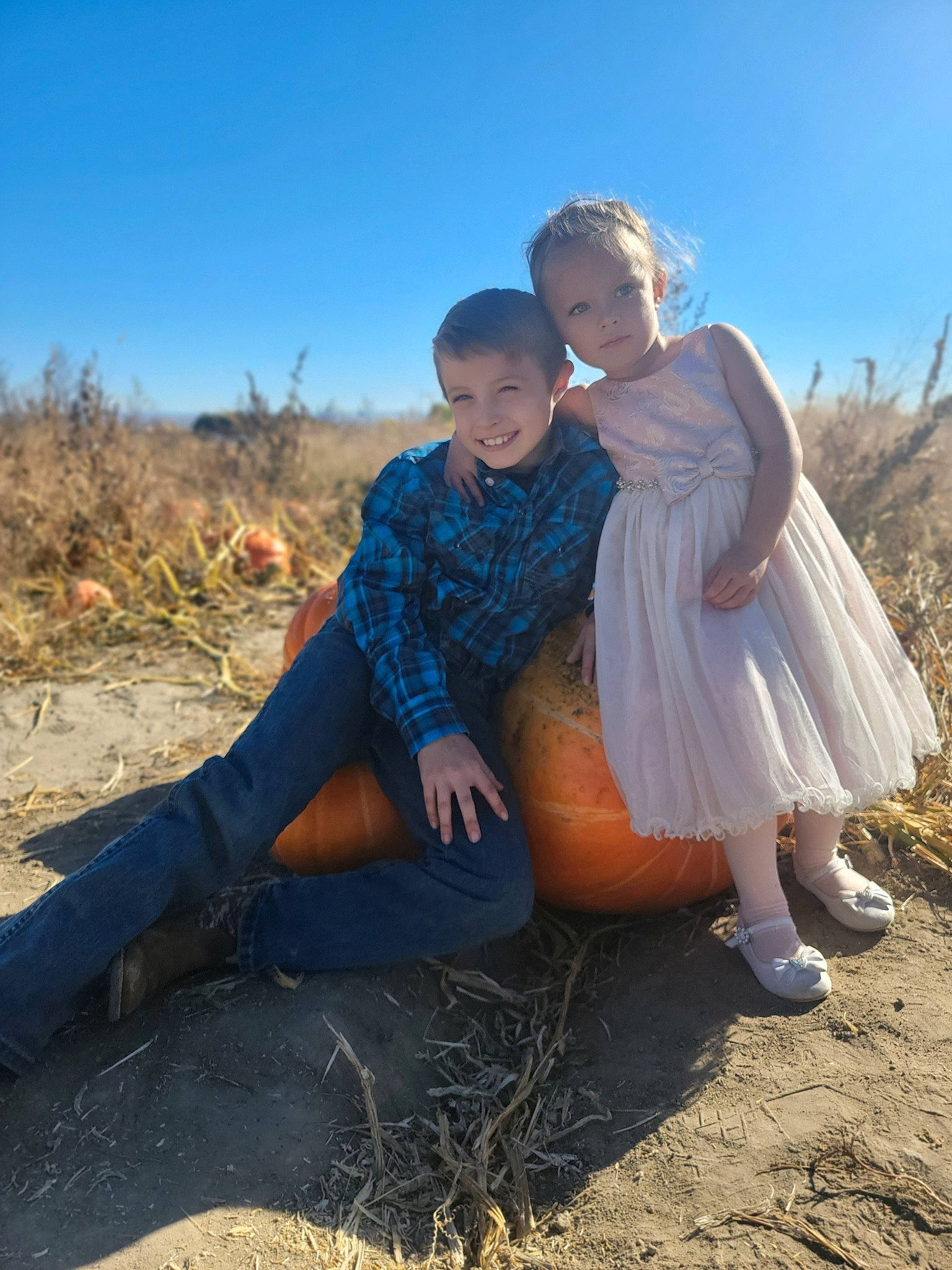 Maliyah joined the competition — help win amazing prizes! boot, dress, face, flash_photography, fun, grass, grassland, happy, horizon, joy, landscape, people_in_nature, person, plant, prairie, pumpkin, sand, sitting, sky, sunlight