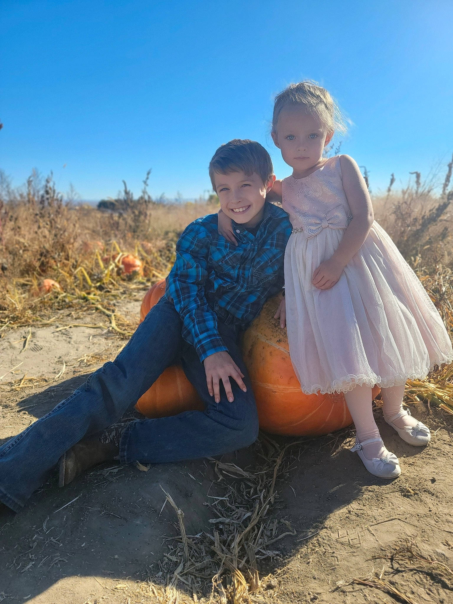Maliyah is registered to the contest to win money with this photo: azure, dress, event, flash_photography, formal_wear, fun, gesture, gown, grass, grassland, happy, human_leg, joy, landscape, people_in_nature, person, plant, prairie, sky, soil