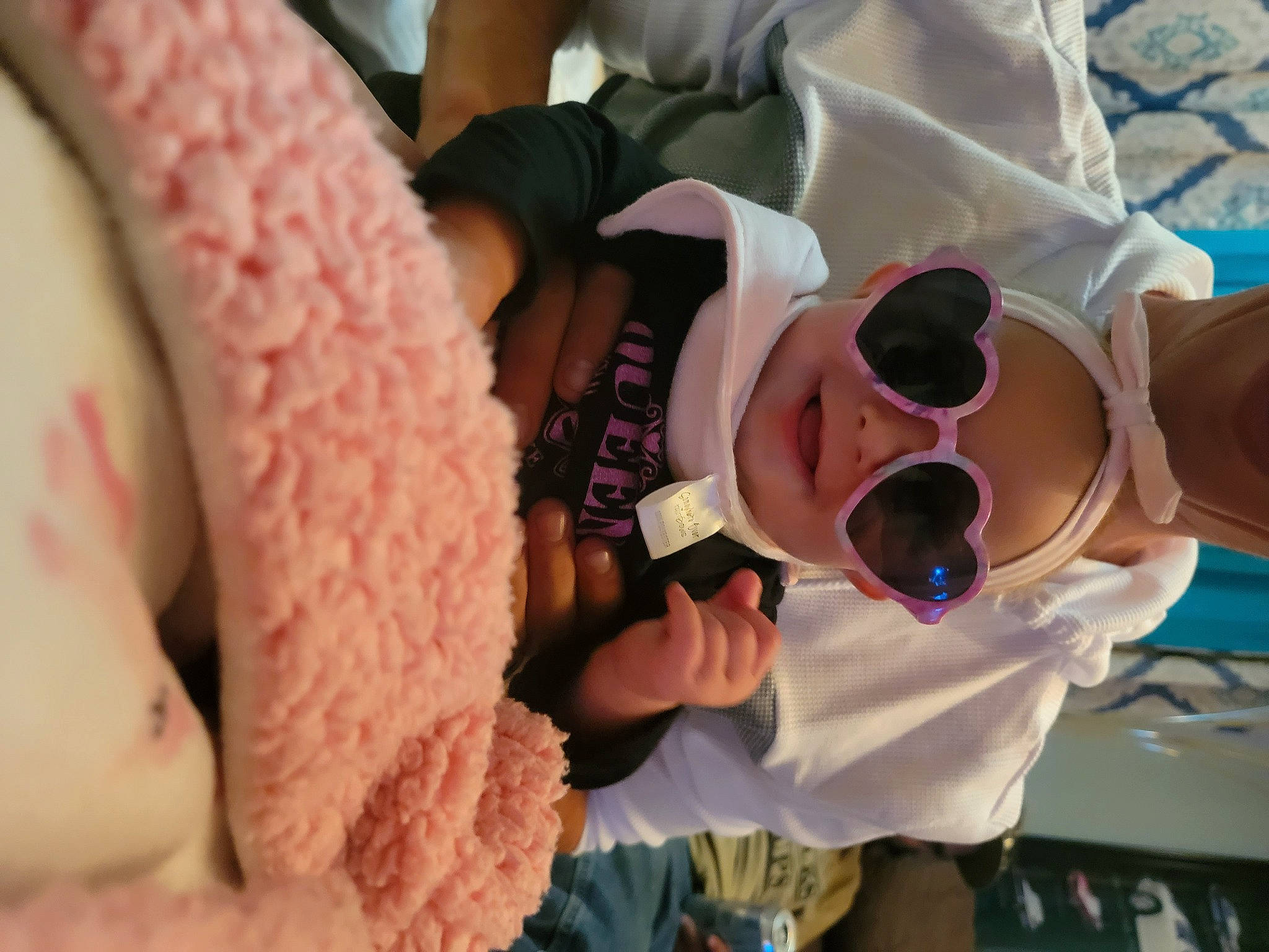 Embrie is registered to the contest to win money with this photo: baby, carmine, child, comfort, eyewear, finger, flesh, food, gesture, happy, headwear, magenta, nail, pattern, peach, person, pink, sunglasses, thumb, toddler