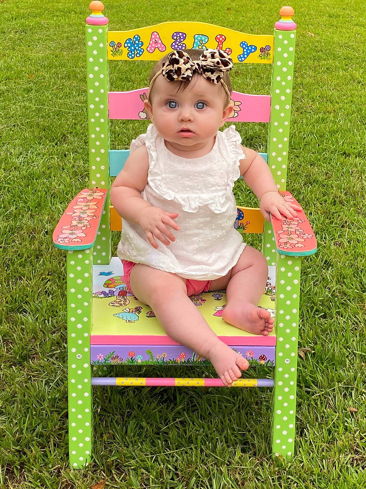 Hazely joined the competition — help win amazing prizes! baby, baby_toddler_clothing, child, fun, grass, green, happy, outdoor_play_equipment, person, pink, plant, play, playground, public_space, sitting, smile, summer, surprise, swing, toddler