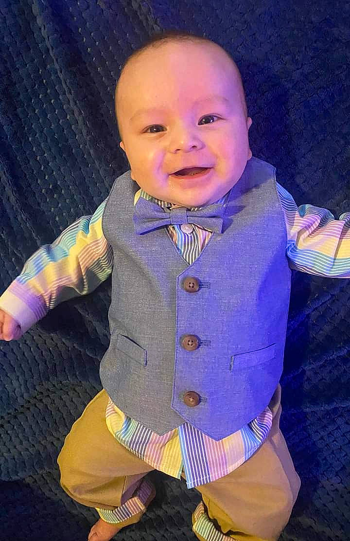 Colson is registered to the contest to win money with this photo: baby, baby_products, baby_toddler_clothing, cheek, collar, electric_blue, face, finger, fun, happy, headgear, magenta, outerwear, pattern, person, personal_protective_equipment, purple, sleeve, smile, t_shirt