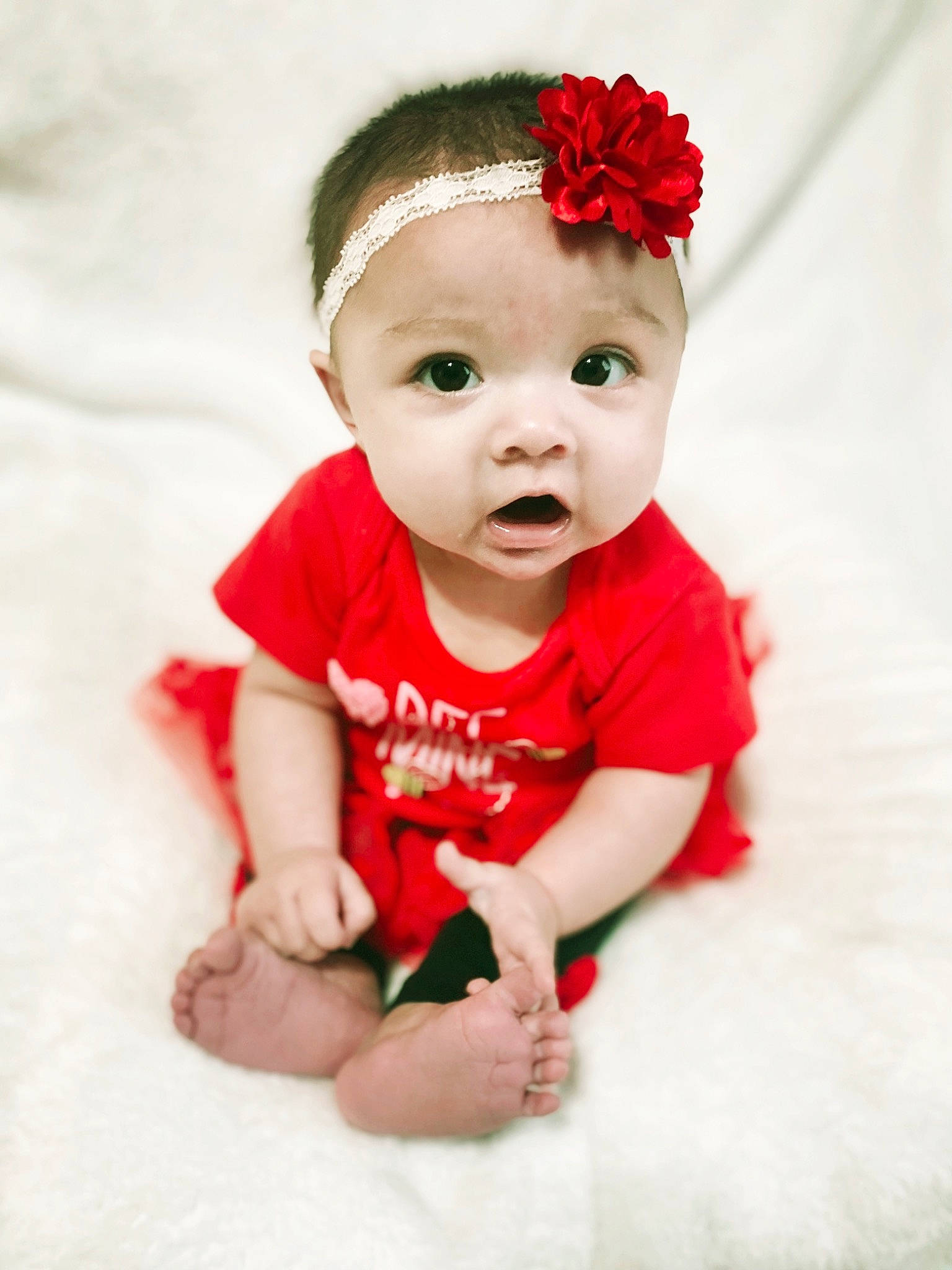 Emberly is registered to the contest to win money with this photo: baby, baby_toddler_clothing, cap, child, costume_hat, face, fashion_accessory, flash_photography, flower, happy, hat, headband, headpiece, pattern, person, petal, pink, sitting, sleeve, t_shirt