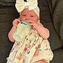baby, infant, bottle, milk, headband, bow, dress, floral, couch, fabric, cute, child, sitting, indoors, skin, person, feeding, comfort, young, relaxing
