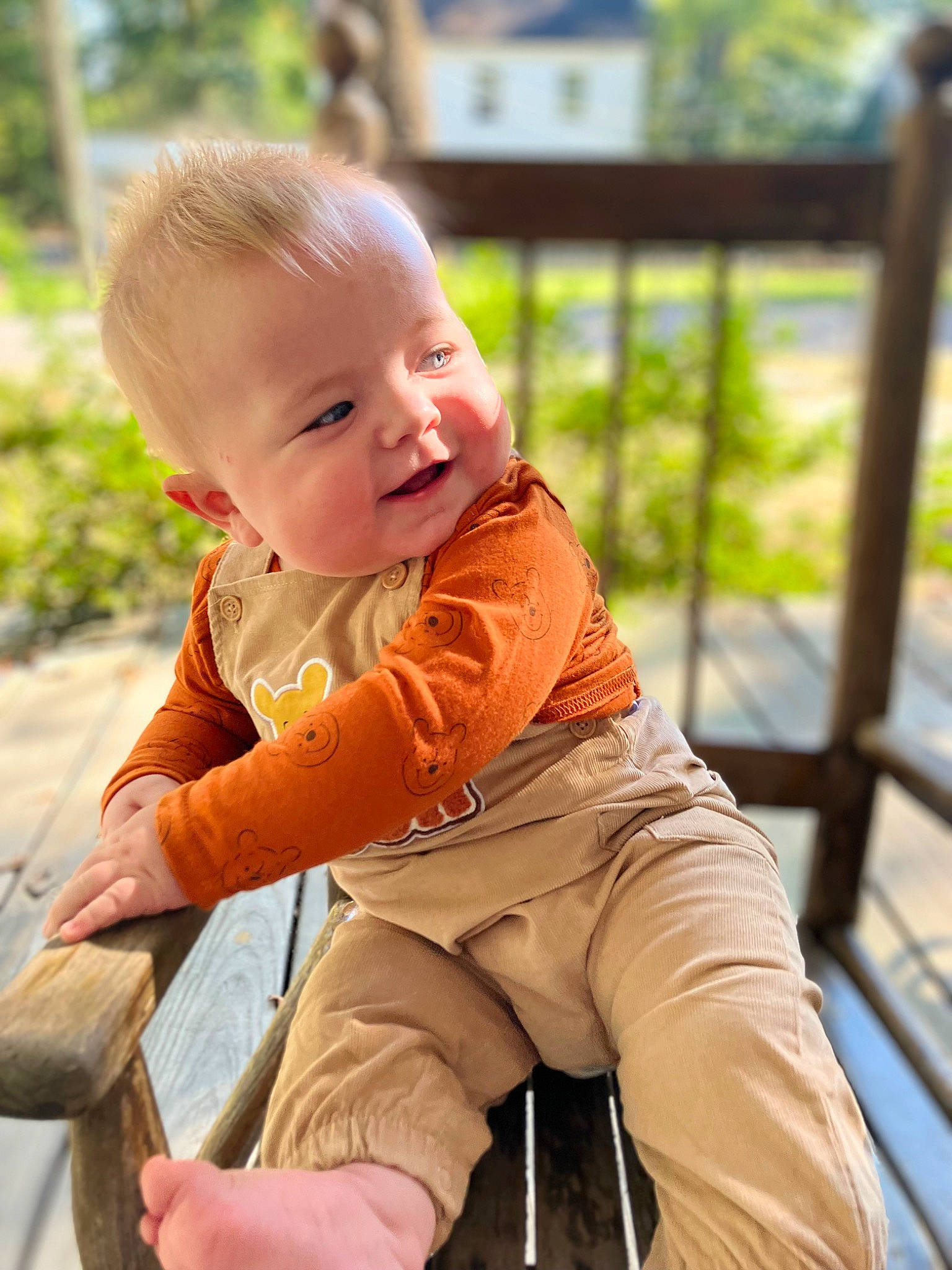 Brentley is registered to the contest to win money with this photo: baby, baby_toddler_clothing, face, fence, fun, grass, happy, head, leg, leisure, people_in_nature, person, plant, recreation, shorts, sitting, skin, smile, toddler, tree