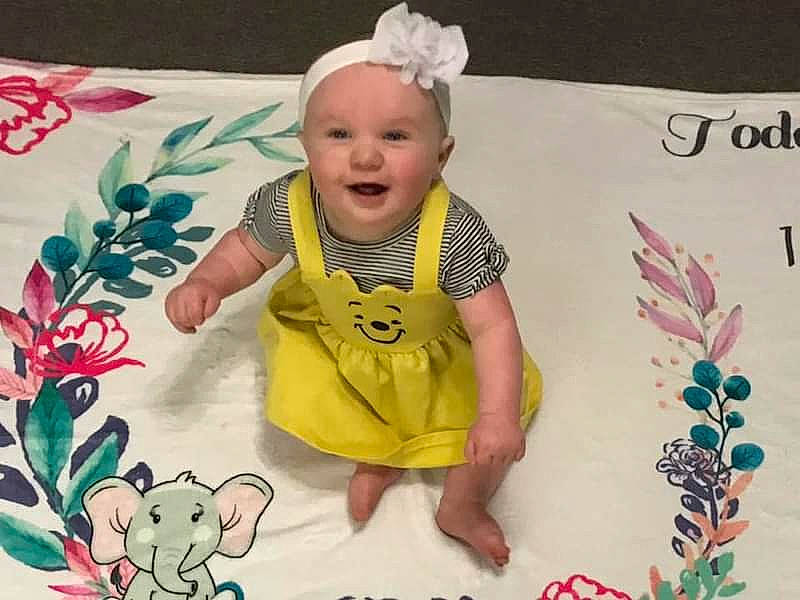 Jade is registered to the contest to win money with this photo: baby, baby_products, baby_toddler_clothing, beauty, cap, child, clothing, fashion_accessory, font, happy, linens, magenta, pattern, person, pink, product, sleeve, smile, t_shirt, textile