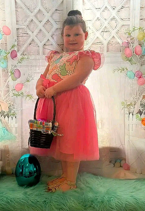 Lilli is registered to the contest to win money with this photo: child, day_dress, dress, event, fashion_design, flooring, fun, green, happy, magenta, pattern, peach, person, pink, room, sitting, smile, textile, tire, toddler