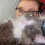Clyde is registered to the contest to win money with this photo: cat, person, glasses, close_up, indoor, couch, feline, pet, cozy, love, whiskers, fur, nap, relaxation, heart_eyes, cute, domestic_animal, portrait, resting, snuggled