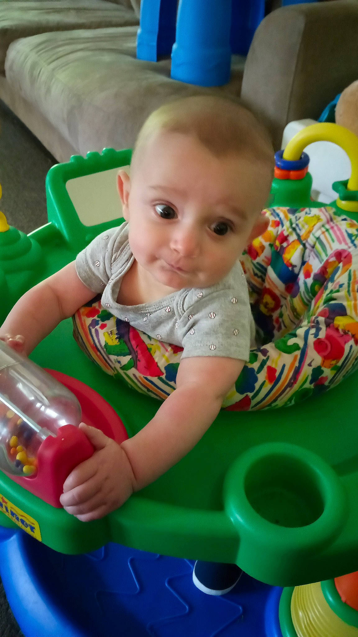 Henry is registered to the contest to win money with this photo: baby, baby_playing_with_toys, baby_toddler_clothing, beauty, blue, child, facial_expression, fun, green, human_body, organ, person, plastic, play, product, riding_toy, sitting, smile, standing, toddler