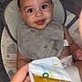 baby, bib, baby_food, high_chair, messy, smiling, happy, child, infant, feeding, cushion, diaper, hand, food_container, indoor, closeup, person, cute, face, seat
