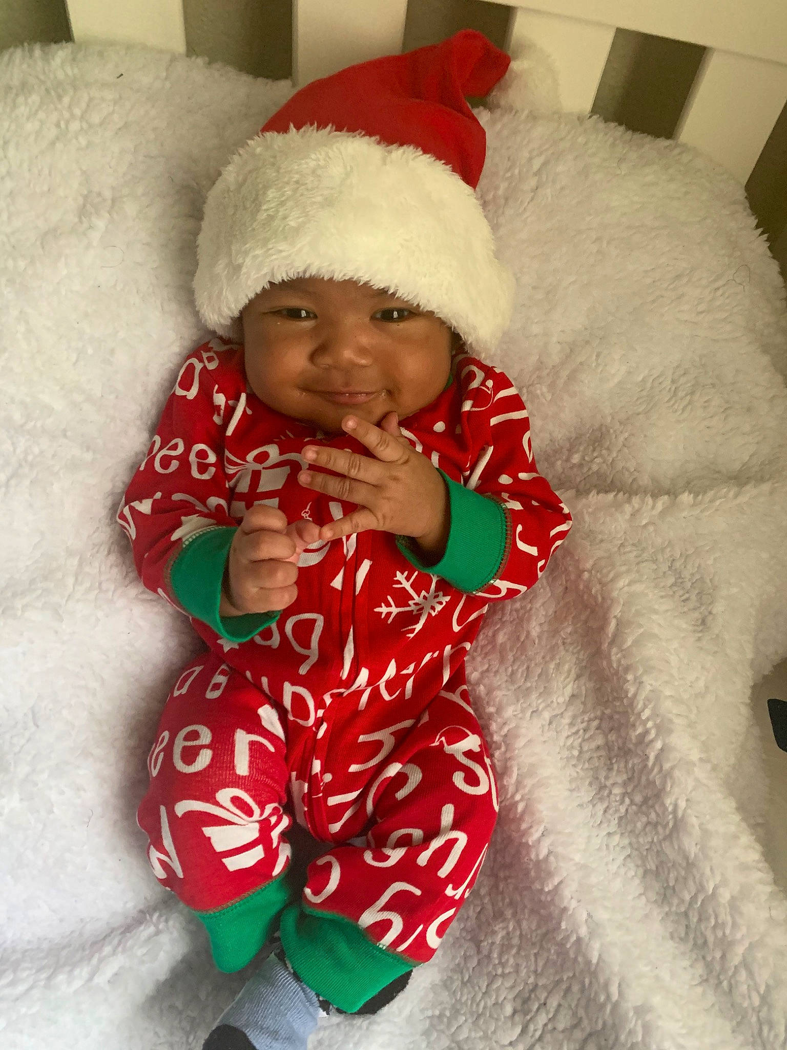Jayceon is registered to the contest to win money with this photo: baby, child, christmas, christmas_eve, event, fictional_character, head, headwear, holiday, person, santa_claus, skin, smile, toddler, winter