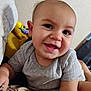Remington joined the competition — help win amazing prizes! baby, child, smiling, face, portrait, gray_shirt, indoor, toy, playful, skin, head, person, young_child, cute, happy, closeup, infant, human, expression, sitting