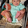 Remington is registered to the contest to win money with this photo: baby, smiling, stroller, blanket, soft_book, clothing, baby_bottle, infant, happy, face, foot, hand, indoor, toy, person, cute, child, skin, head, comfort