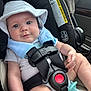baby, car_seat, harness, pacifier, hat, infant, child, seatbelt, safety, car_interior, warning_label, cute, smiling, portrait, closeup, blue, white_clothing, skin, hand, vehicle