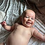 Elijah joined the competition — help win amazing prizes! baby, smiling, drool, diaper, bed, patterned_sheet, happy, infant, skin, face, arm, lying_down, cute, child, young, natural_light, indoors, blanket, cheerful, relaxed
