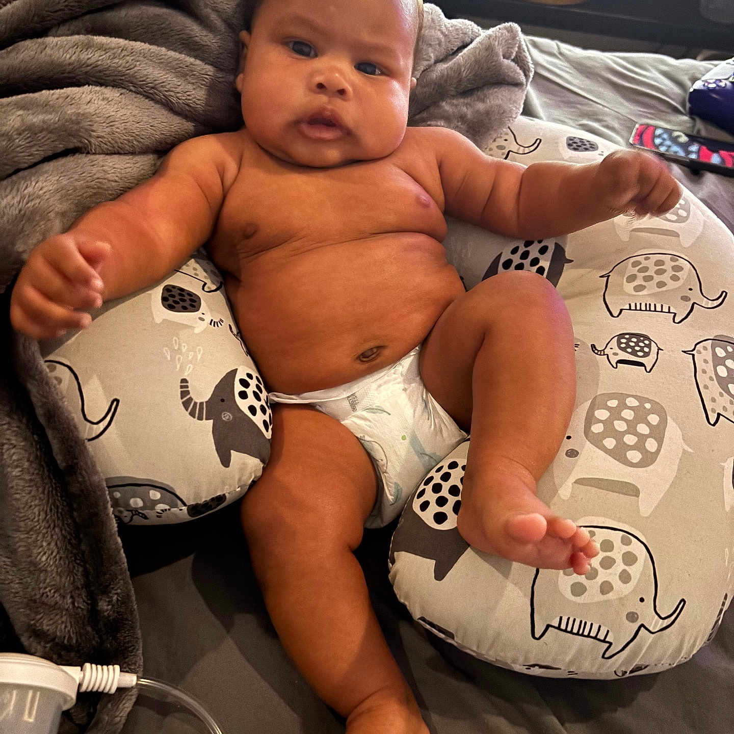 Kobe Jr. is registered to the contest to win money with this photo: baby, blanket, bodypart, clothing, couch, cushion, diaper, face, finger, furniture, hand, head, homedecor, newborn, person, photography, pillow, portrait, shorts, sitting