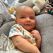 Luchi joined the competition — help win amazing prizes! baby, infant, smile, onesie, animal_print, blanket, plush_toy, cushion, soft_toys, closeup, indoors, child, cute, relaxed, portrait, baby_clothing, happy, person, young_child, cozy