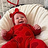 Oakley is registered to the contest to win money with this photo: baby, infant, red_outfit, headband, heart_pattern, smiling, plush_cushion, newspaper_background, red_yarn, love, heart_shape, cozy, indoor, cute, happy, portrait, child, soft_texture, creative_background, comfortable