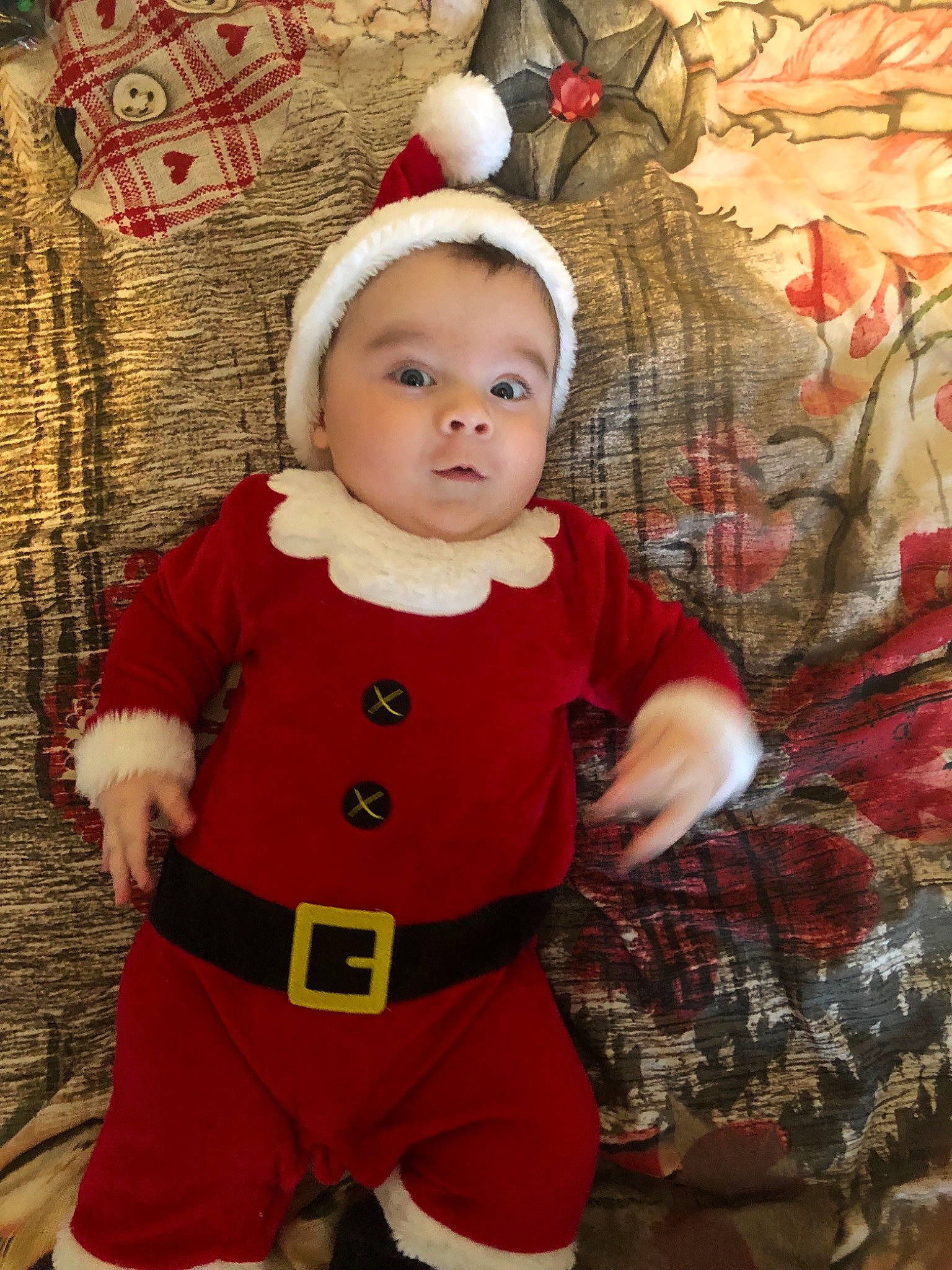 Andi is registered to the contest to win money with this photo: baby, child, christmas, christmas_eve, fictional_character, holiday, person, red, santa_claus, toddler, tree