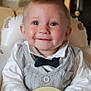 baby, child, smile, face, blue_eyes, bow_tie, vest, white_shirt, high_chair, indoor, cute, happy, portrait, dimple, infant, clothing, person, seat, toy, baby_furniture