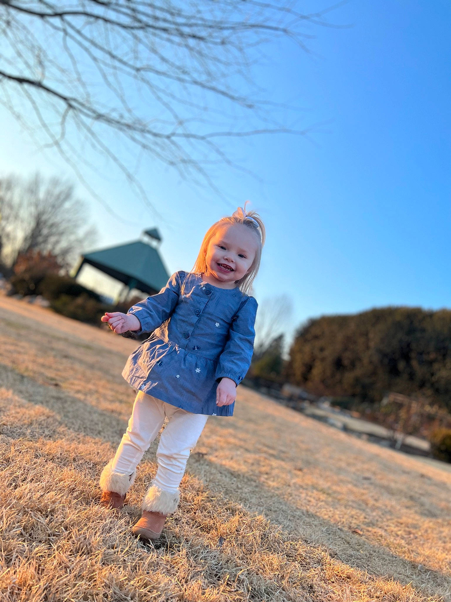 Ashlynn is registered to the contest to win money with this photo: denim, electric_blue, flash_photography, freezing, grass, grassland, happy, joy, landscape, leisure, nature, people_in_nature, person, plain, plant, prairie, sky, soil, toddler, tree