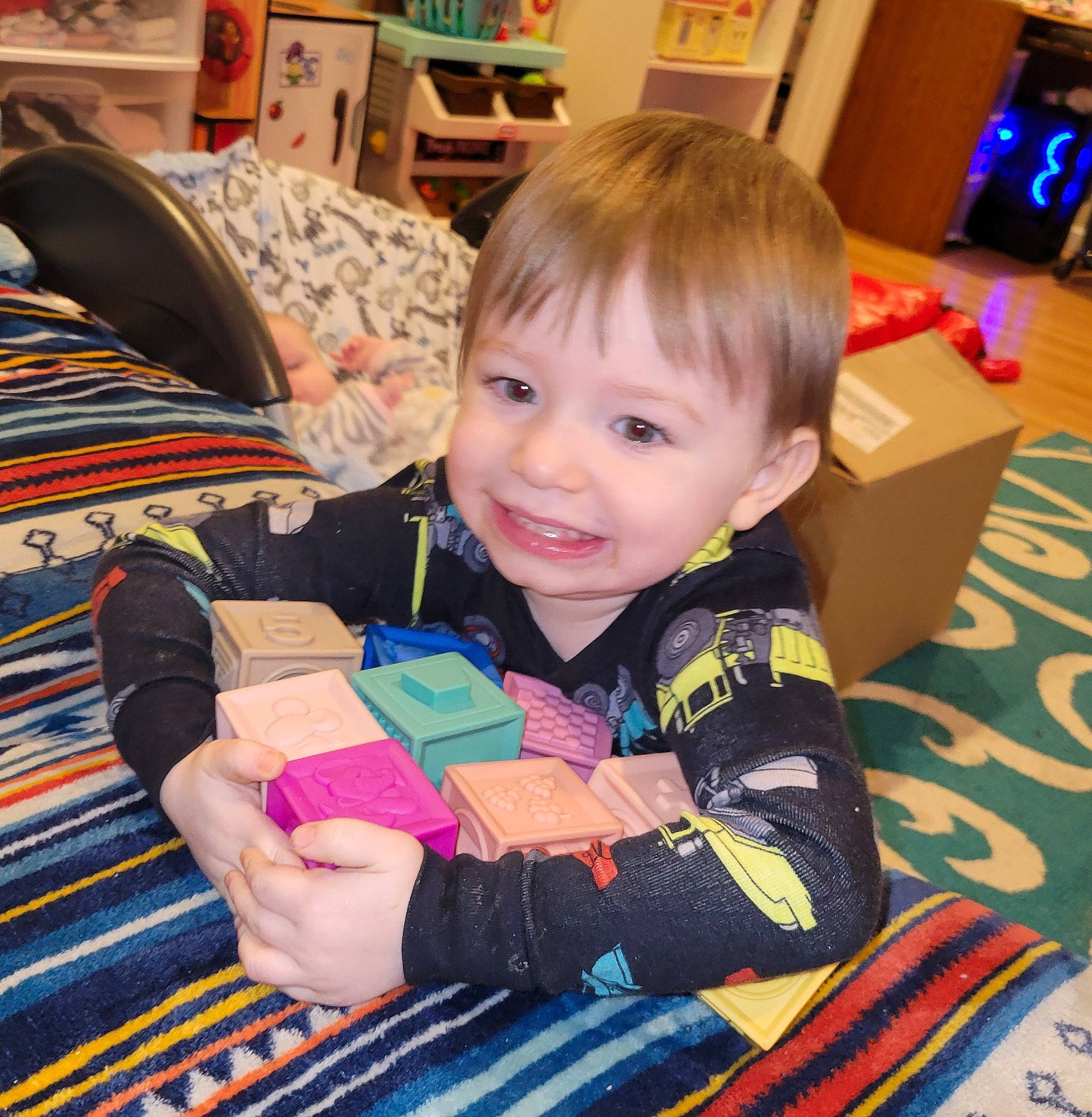 Damien is registered to the contest to win money with this photo: baby, baby_toddler_clothing, chair, child, comfort, event, flooring, fun, holiday, joy, lap, linens, living_room, pattern, person, play, room, sitting, skin, smile