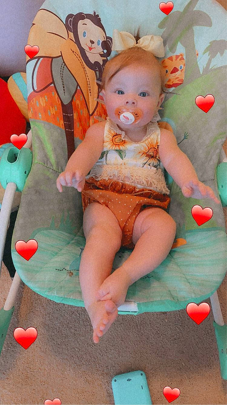 Brenleigh joined the competition — help win amazing prizes! baby, baby_toddler_clothing, child, foot, fun, hairstyle, happy, human_leg, lap, leg, leisure, mouth, orange, person, pink, sitting, skin, smile, textile, thigh