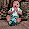 baby, child, infant, smiling, laughing, sitting, portrait, indoors, couch, cushions, brick_wall, clothing, striped_shirt, shorts, socks, hands, happy, home, cozy, photography