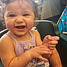 Braelynn is registered to the contest to win money with this photo: toddler, child, smiling, curly_hair, high_chair, dress, lavender, indoor, window, happy, cute, baby, person, skin, face, arm, hand, foot, seated, playful