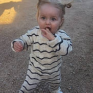 Louanna participe au concours pour gagner de l'argent avec cette photo : casual_wear, child, curious, cute, daylight, expression, fashion, gravel, hair_buns, innocent, outdoor, person, playful, shoes, small_child, standing, striped_clothing, sunlight, toddler, young_child