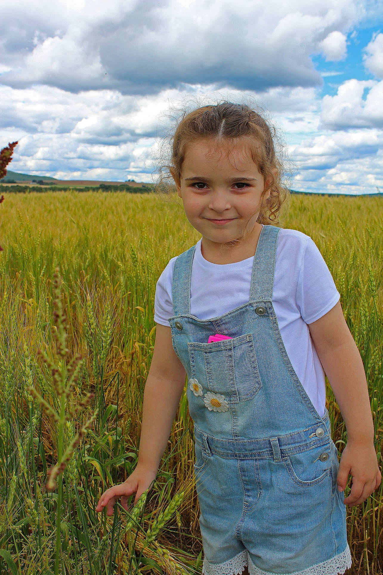 Mackiah is registered to the contest to win money with this photo: agriculture, baby_toddler_clothing, blond, child, cloud, electric_blue, grass, grassland, green, happy, joy, landscape, meadow, people_in_nature, person, plant, prairie, sky, sleeve, smile