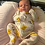baby, infant, onesie, yellow_dogs, rainbows, pink_cushion, soft_texture, sleepy, curious, cute, clothing, child, portrait, indoor, resting, newborn, small, cute_pattern, fabric, relaxed