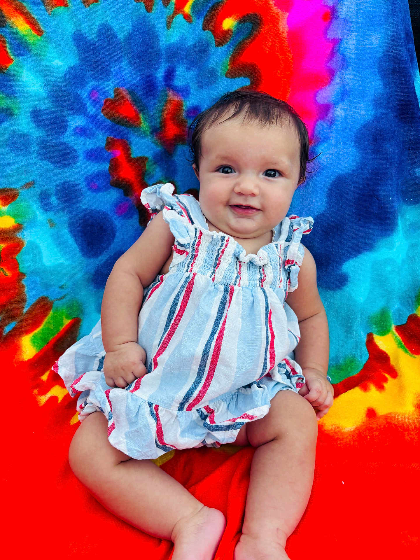 Hazel joined the competition — help win amazing prizes! baby, child, smiling, striped_dress, tie_dye_blanket, colorful_background, sitting, happy, cute, portrait, infant, skin, face, blue, red, orange, yellow, green, pink, outdoor
