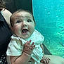 Hazel joined the competition — help win amazing prizes! baby, child, person, smile, happy, aquarium, fish, water, glass, adult, hand, skin, clothing, sitting, indoor, cute, curious, light, face, portrait