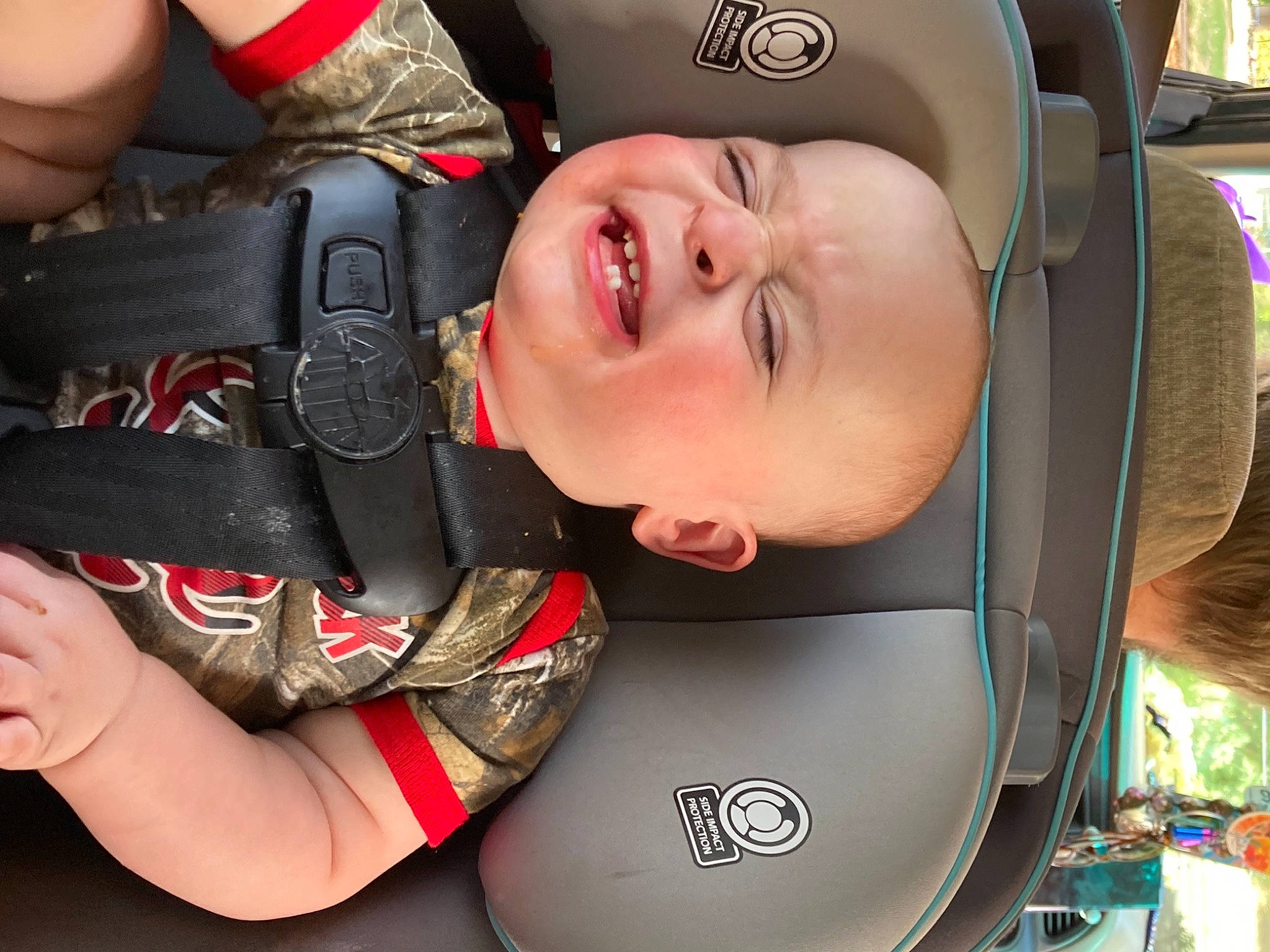 Malachi is registered to the contest to win money with this photo: auto_part, baby, baby_carriage, car_seat, child, comfort, cool, finger, fun, gesture, hand, happy, headgear, helmet, mouth, person, personal_protective_equipment, skin, smile, sports_gear