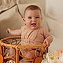 baby, infant, basket, smiling, face, cute, flower, decor, indoor, child, neutral_colors, cushion, soft_light, portrait, happy, sitting, cozy, skin, young, home