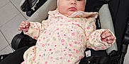 Miah joined the competition — help win amazing prizes! baby, infant, child, stroller, headband, pink, floral, clothing, toddler, cute, indoors, seat, relaxed, legs, hands, face, expression, tile_floor, soft_lighting, casual