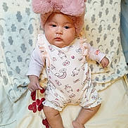 Miah joined the competition — help win amazing prizes! baby, infant, pink_bow, hat, romper, blanket, cloud_pattern, star_pattern, cute, chubby_cheeks, lying_down, indoors, soft_texture, child, sleepwear, foot, hand, calm_expression, portrait, cozy