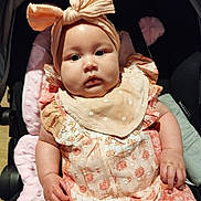 Miah joined the competition — help win amazing prizes! baby, child, stroller, headband, bow, clothing, pink, orange, pattern, infant, cute, face, portrait, sitting, hand, apparel, fabric, soft, adorable, young