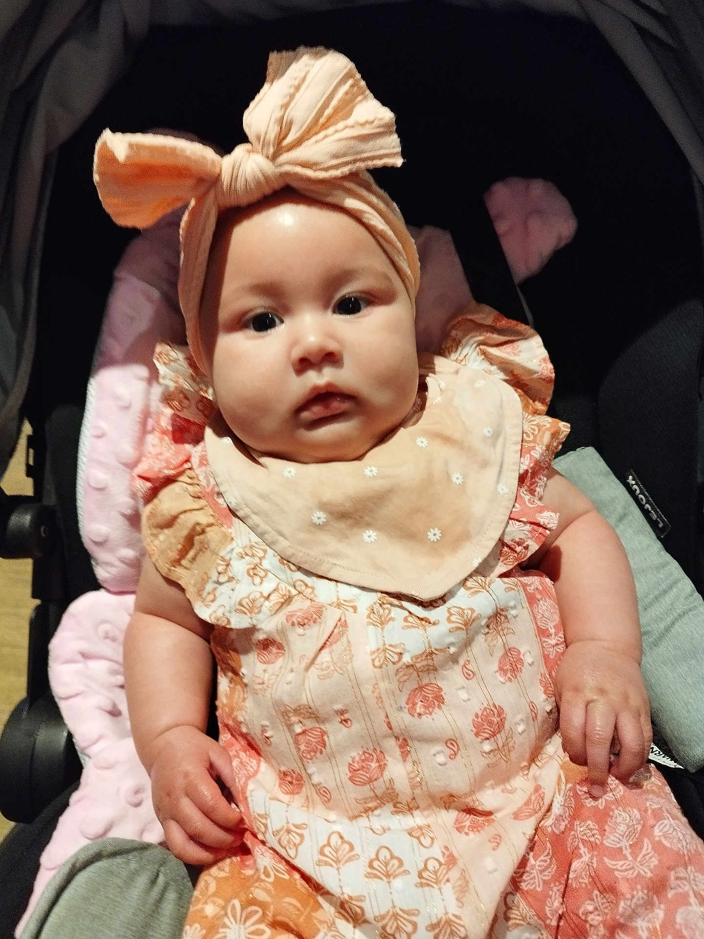 Miah joined the competition — help win amazing prizes! baby, child, stroller, headband, bow, clothing, pink, orange, pattern, infant, cute, face, portrait, sitting, hand, apparel, fabric, soft, adorable, young